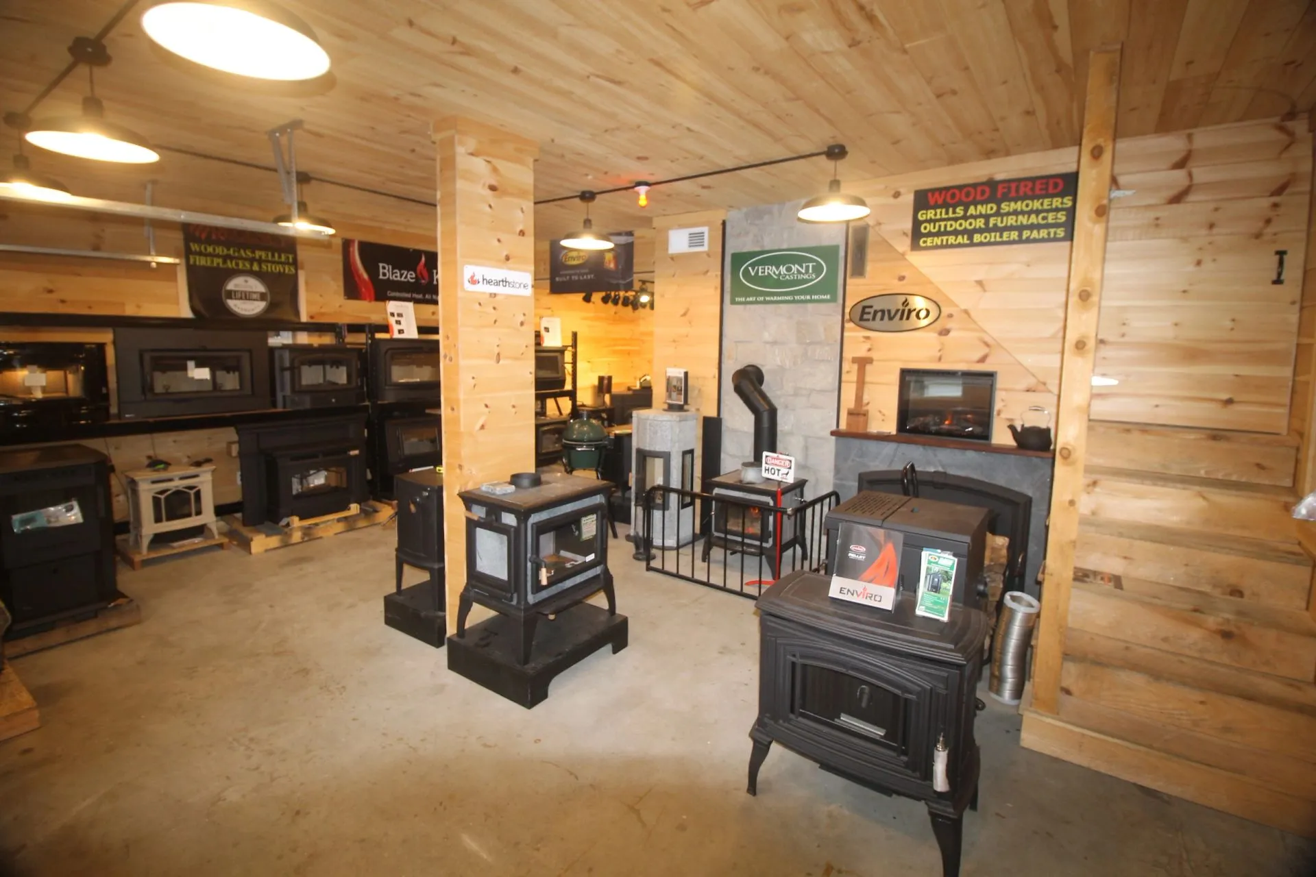 Wood and gas stoves burning on display in the Pondside hearth showroom